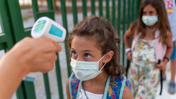 Student gets temperature checked at school
