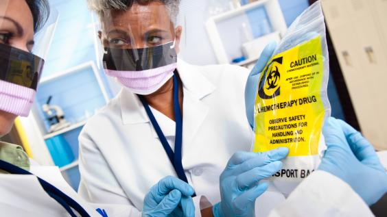 Doctor administering chemotherapeutic drugs