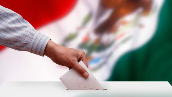 Ballot box in front of the Mexican flag