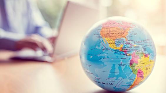 A globe sits on a desk.