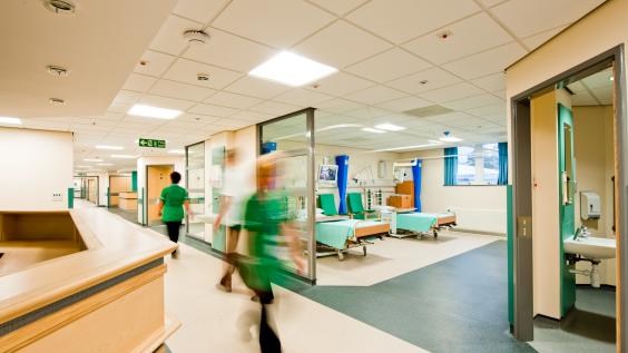 Nurses walk inside a hospital.