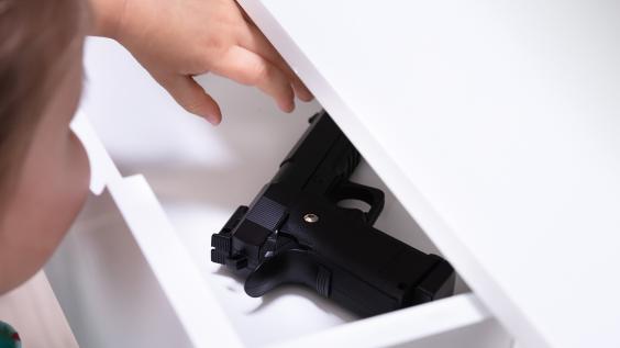 Child opening drawer containing gun