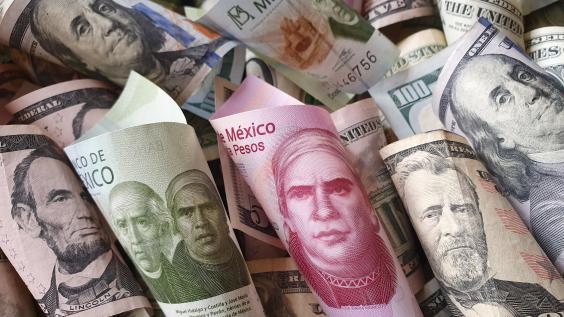 A mix of Mexican pesos and U.S. dollar bills.