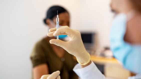 A nurse administers a COVID-19 vaccination.