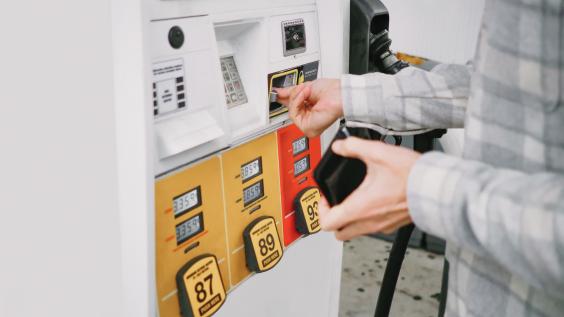 A person pays for gas at the pump.