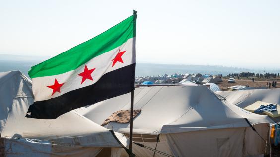 The Syrian revolution flag waves over refugee camps.