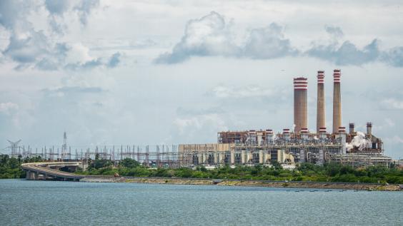 A Pemex refinery in Mexico, viewed from across a body of water.