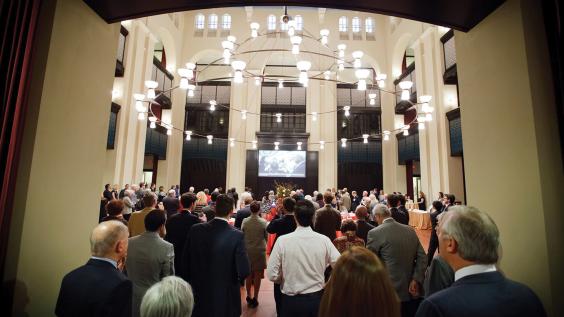 Event attendees enter Doré Commons for a reception