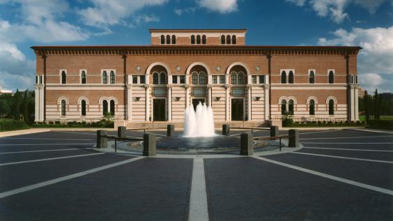 The front of Baker Hall, from across the plaza, with fountain in foreground