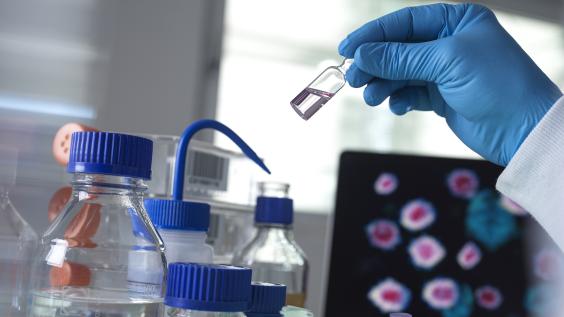 Scientist holding a vial