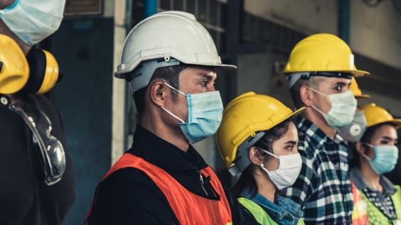 Construction workers wear masks.