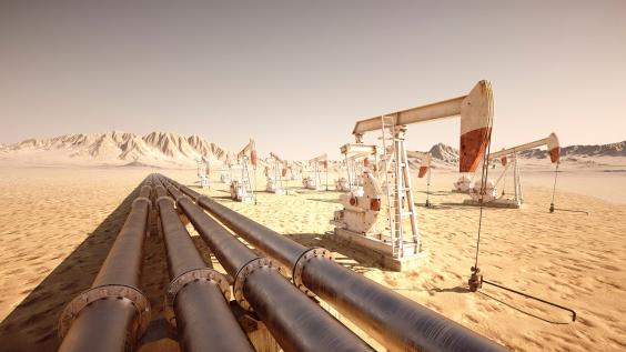 Pump jacks and pipelines move oil through the desert