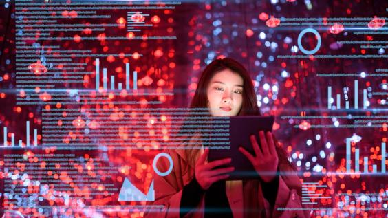 Young woman uses digital tablet on virtual visual screen at night