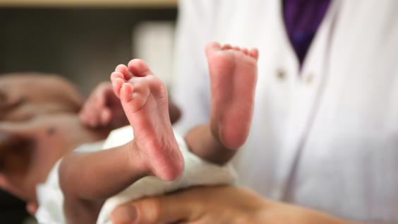 Newborn baby and doctor