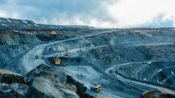 Trucks and the excavator in an open pit 