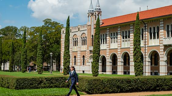 A students walks through Rice University campus