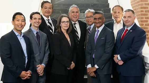 Group of event speakers posing for photo