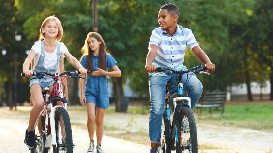  Friends riding bicycles and walking in the park