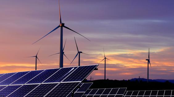 Solar panels in front of wind turbines