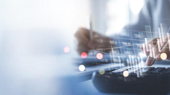 financial information superimposed over hands above keyboard