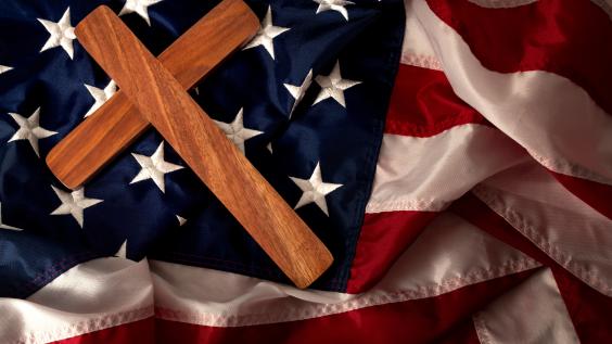  a wooden cross on the american flag