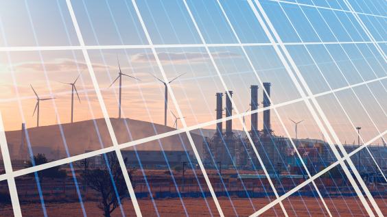 Natural gas processing plant with renewable energy wind turbines generating electricity reflection to solar panels at sunset