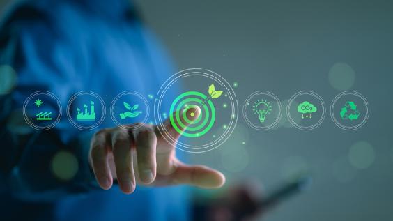 Business person touches a virtual screen displaying icons like renewable energy, co2 emissions reduction, green production, waste recycling, and solar power.