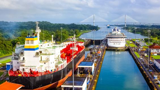 Two cargo ships transiting the Panama Canal.