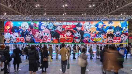 Huge placard showcasing manga heroes like Luffy featured in Weekly Jump magazine at the annual free event Jump Festa '23 in Makuhari Messe International Exhibition Hall.