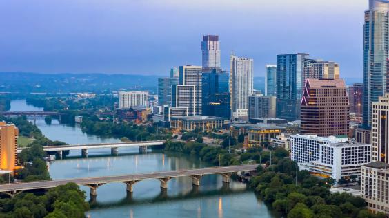 Colorado River and downtown city skyline of Austin at sunrise.