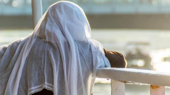  Licensed Find Similar File #:  94934002 Muslim woman on the fence of a boat overlooking the sea at sunset