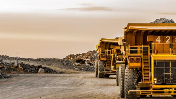 Mining dump trucks transporting Platinum ore for processing