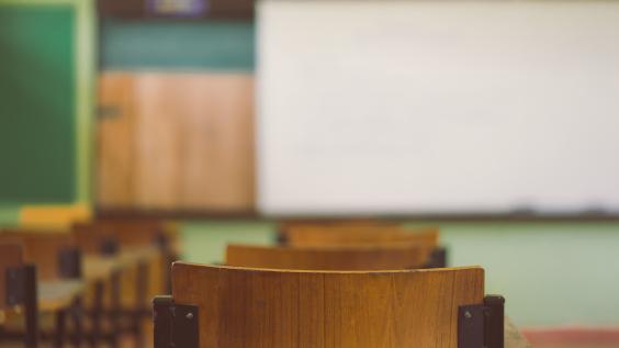 Lecture room or Examination room.School empty classroom with desks and chair.