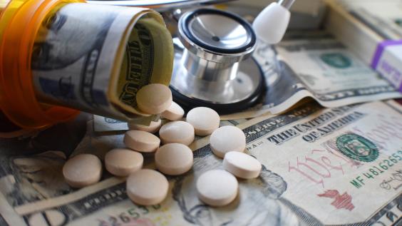 Pill bottle with pills and dollar bill rolls inside
