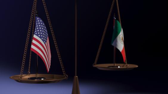 Scale holding Mexican and American flags