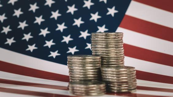 stacks of metal money are on the American flag. Financial system city concept. US coins and American flag 