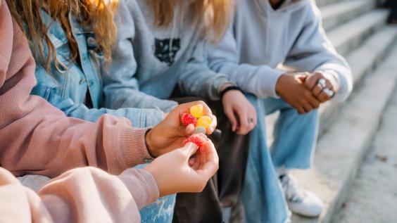 Children holding weed gummies