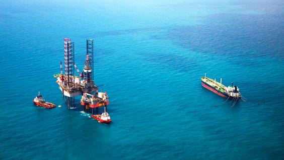 Oil rigs sitting in the ocean