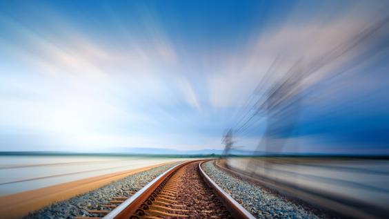 train tracks with motion of fast train visible at right