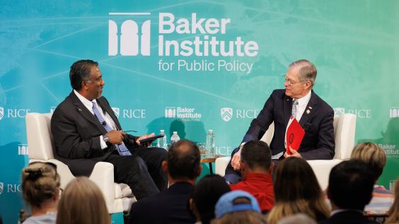Paul Cherukuri and Rep. Brian Babin seated on stage at Baker Hall