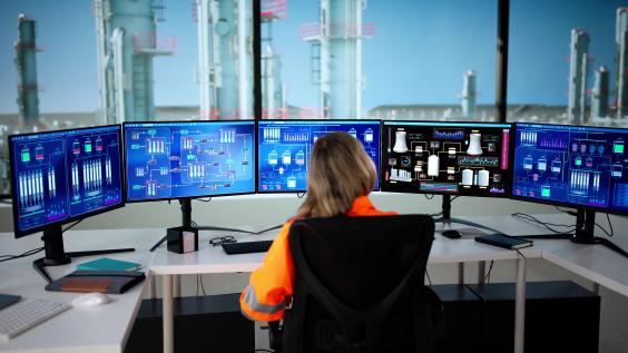 Woman watching oil and gas infrastructure monitors