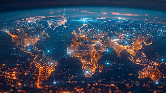 A world map with global network connections on the background of city lights at night.