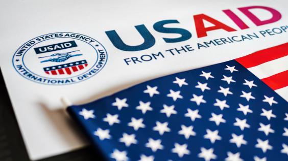 USAID logo letterhead and US flag in foreground 