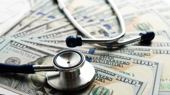 Stethoscope on top of U.S. bills