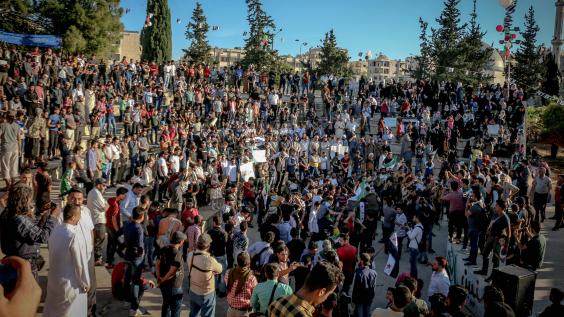 Unrecognizable crowd of ethnic protesters during rally on city street