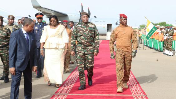 military officers on red carpet at airport
