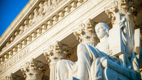  Equal Justice Under Law inscription in the neoclassical columned facade at the entrance to the US Supreme Court building in Washington DC 