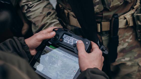 A group of Ukrainian military using tablet to operate the drone.
