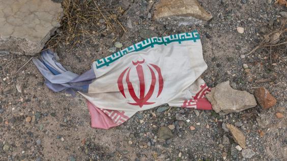 Iranian flag amidst debris