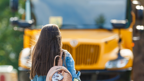 Student walking toward school bus